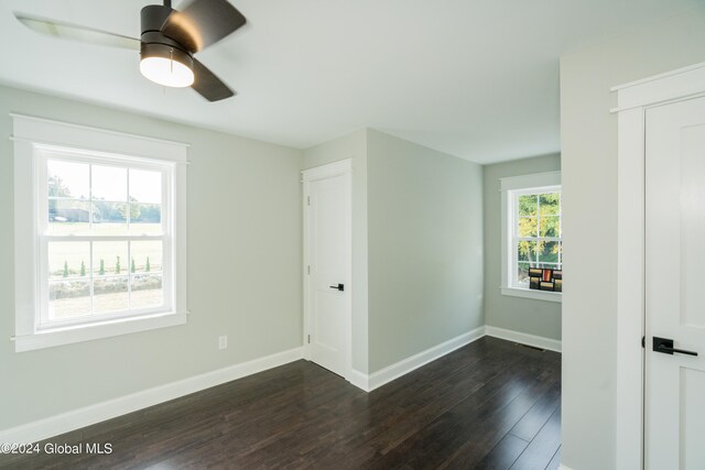 spare room with ceiling fan and dark hardwood / wood-style flooring