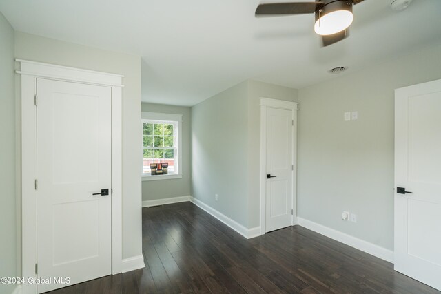 empty room featuring ceiling fan and dark hardwood / wood-style flooring