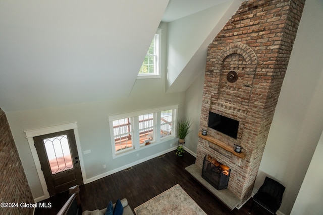 living room featuring dark hardwood / wood-style floors and a large fireplace