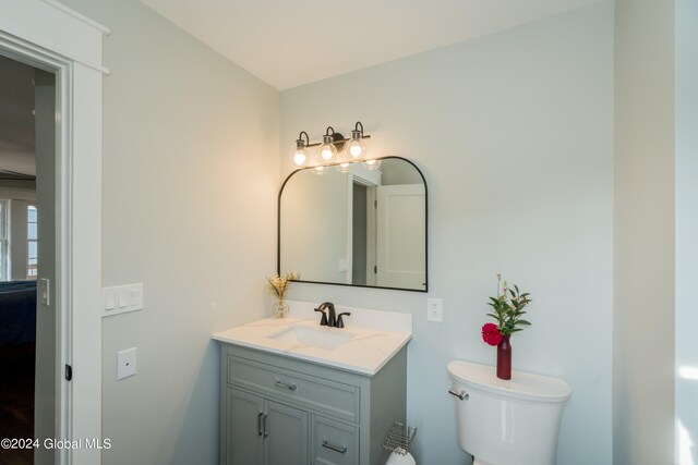 bathroom featuring vanity and toilet