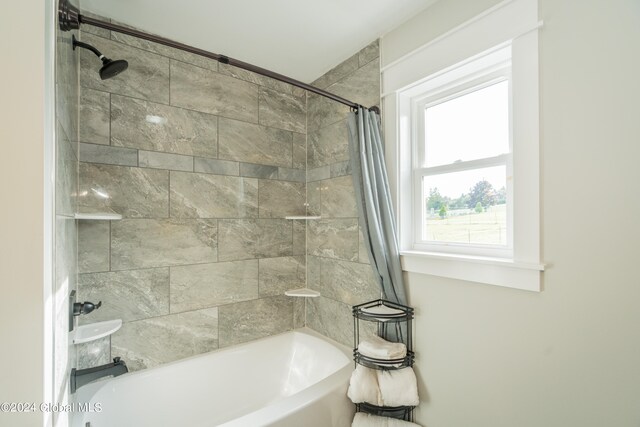 bathroom with shower / bathtub combination with curtain