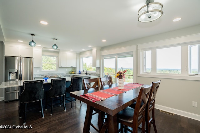 dining room with dark hardwood / wood-style flooring and sink