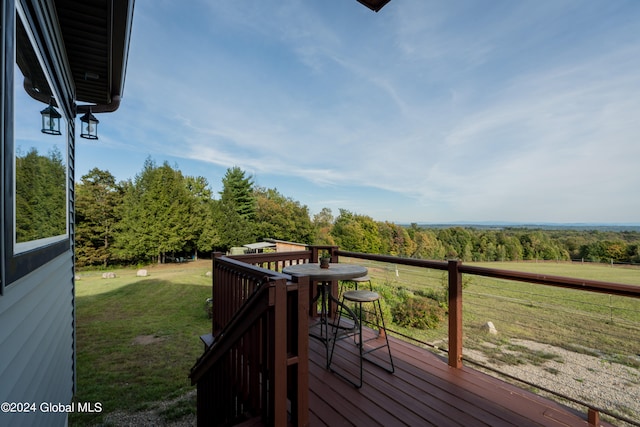 wooden deck with a lawn