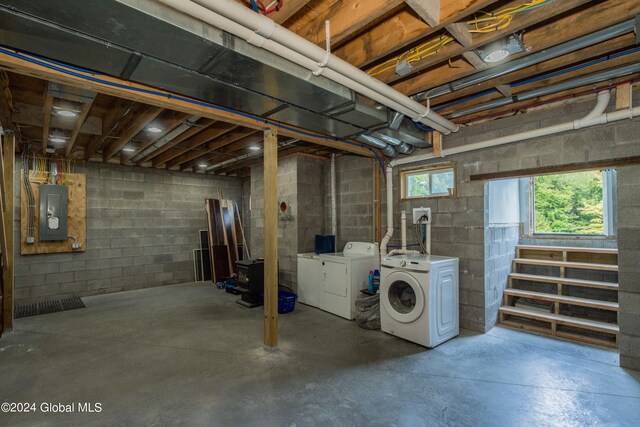 basement with electric panel and independent washer and dryer