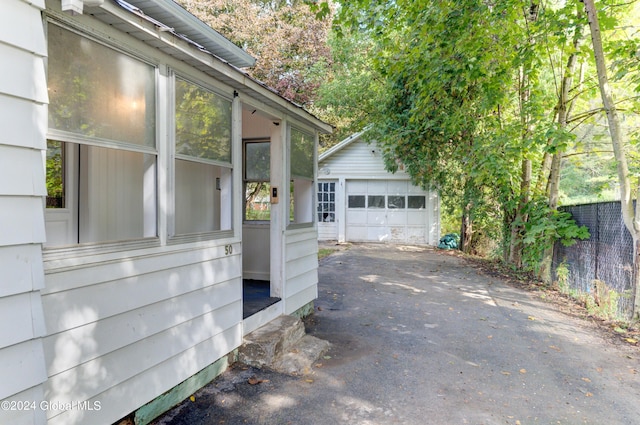 view of patio / terrace with an outbuilding and a garage