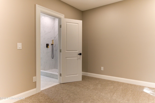 interior space featuring carpet floors and ensuite bath