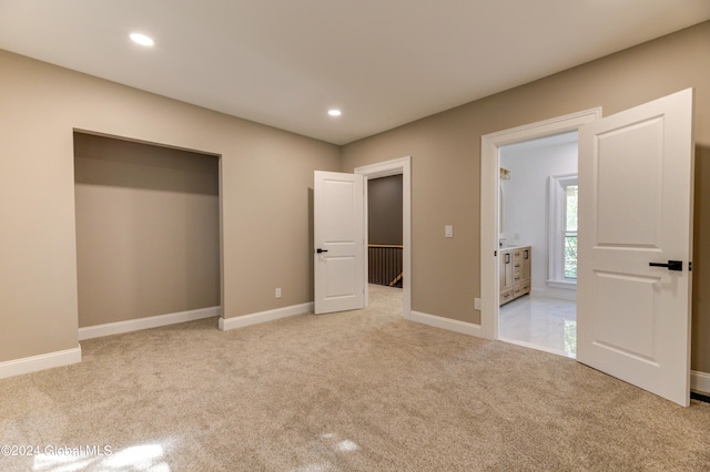 unfurnished bedroom featuring light colored carpet