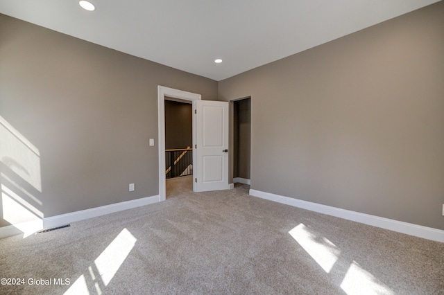 unfurnished bedroom with light carpet