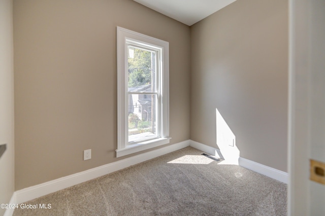 unfurnished room featuring light colored carpet