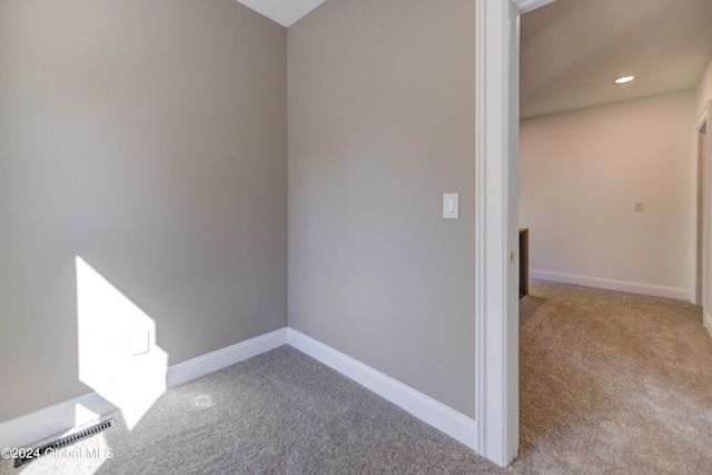 spare room featuring light colored carpet