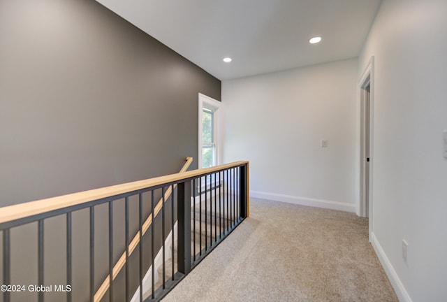 corridor featuring light colored carpet