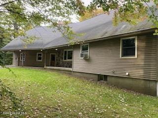 back of house featuring cooling unit and a lawn