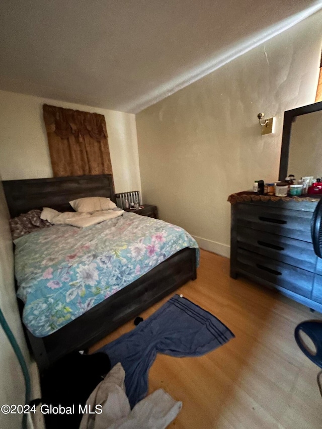 bedroom with hardwood / wood-style floors