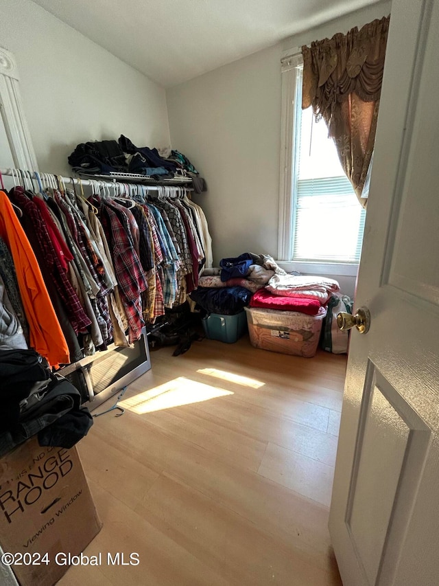 spacious closet with light hardwood / wood-style floors