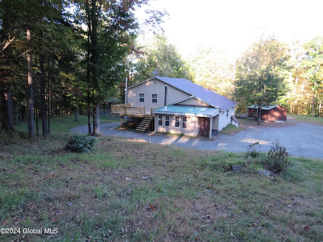 view of yard with a storage shed and a deck