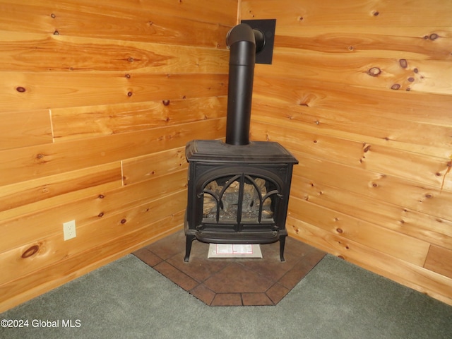 room details featuring carpet and a wood stove