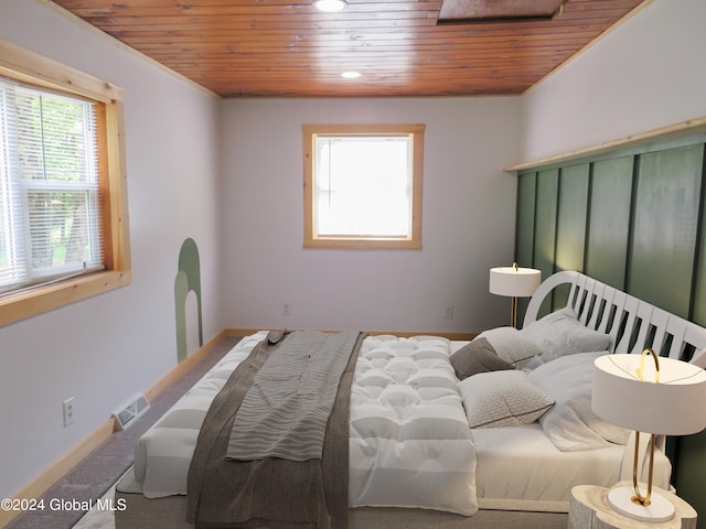 carpeted bedroom with wooden ceiling