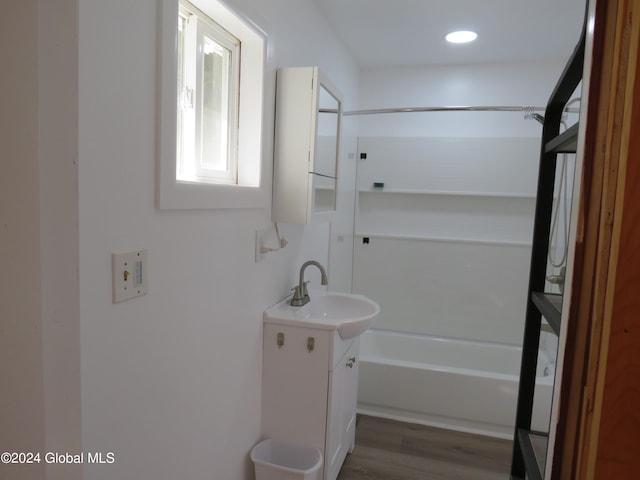 bathroom with vanity, bathtub / shower combination, and hardwood / wood-style flooring