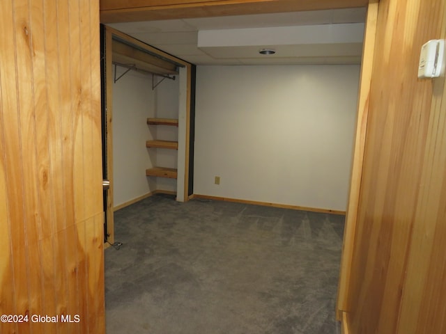 basement featuring dark carpet