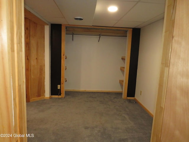 basement featuring carpet floors and a drop ceiling