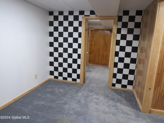 carpeted empty room with a drop ceiling