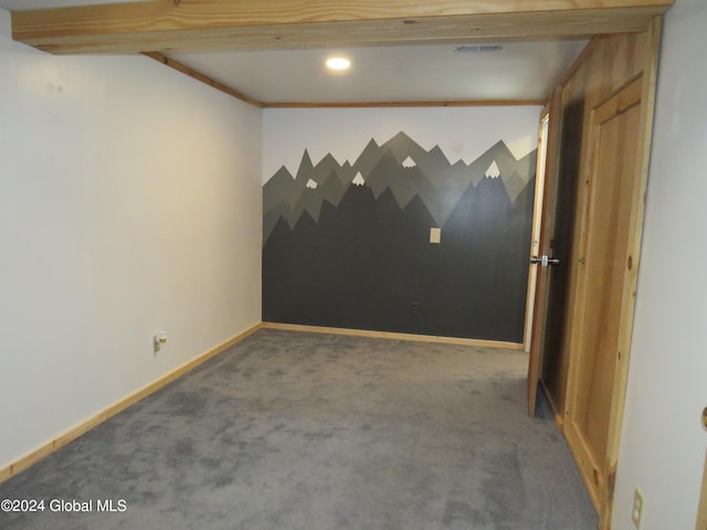 carpeted empty room with crown molding and beam ceiling