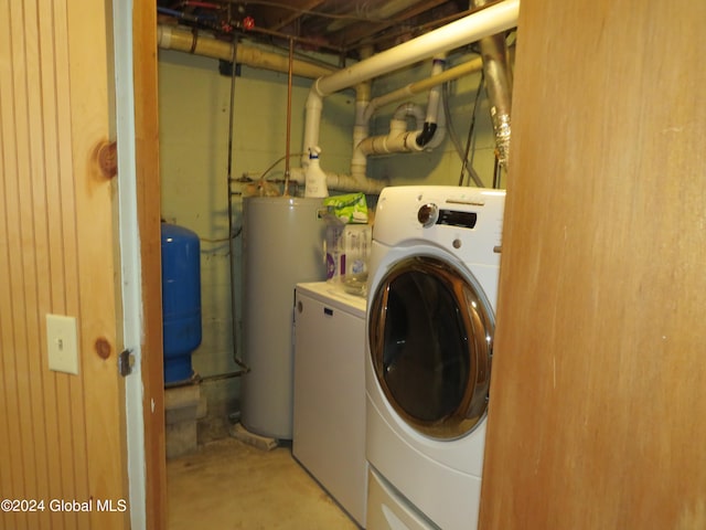 clothes washing area with water heater and washing machine and clothes dryer