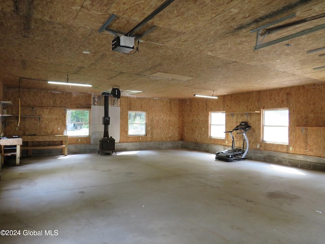 garage featuring a wood stove and a garage door opener