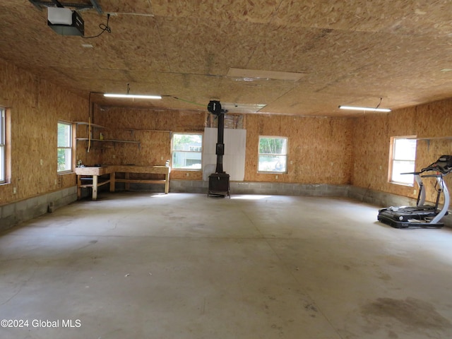 garage featuring a garage door opener and a wood stove