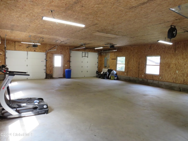 garage with electric panel and a garage door opener