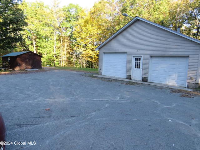 view of side of home featuring an outdoor structure and a garage