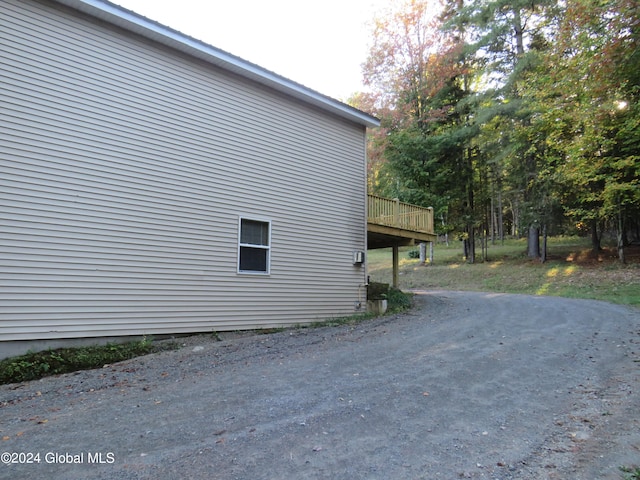 view of property exterior with a deck