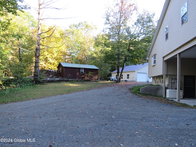 exterior space with ac unit and an outbuilding