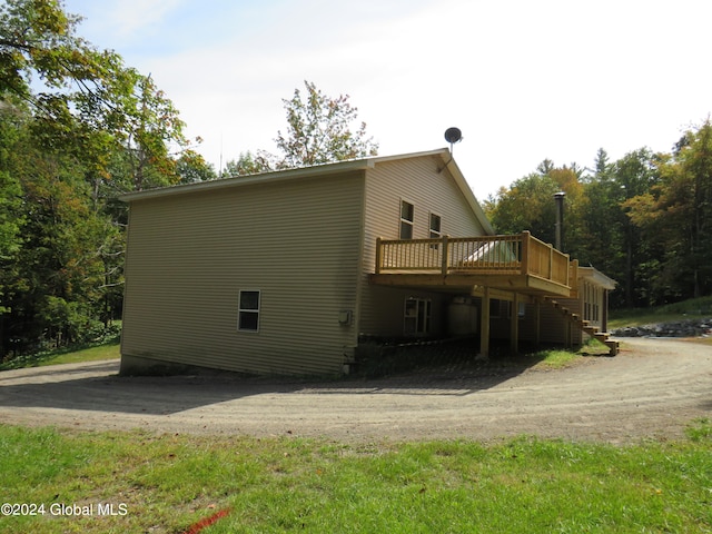 rear view of property featuring a deck