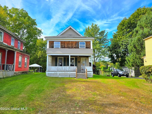 view of front of house featuring covered porch and a front yard