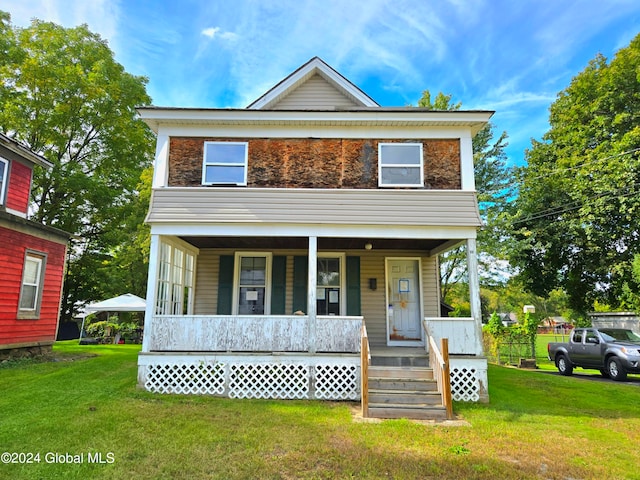 view of front of property with a front yard and covered porch