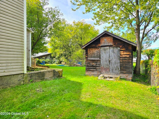 view of outbuilding with a yard