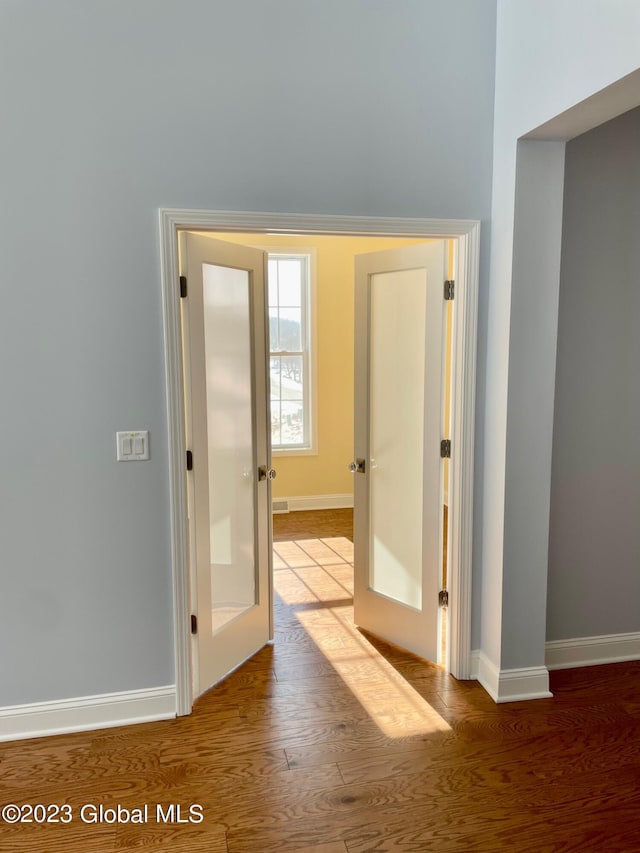 hall featuring french doors and hardwood / wood-style flooring