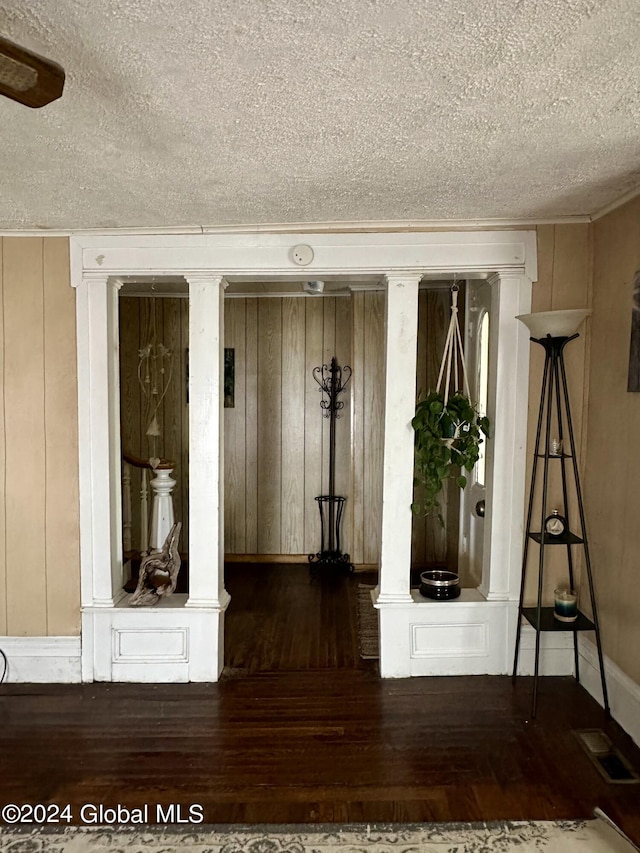 misc room with a textured ceiling and dark hardwood / wood-style flooring