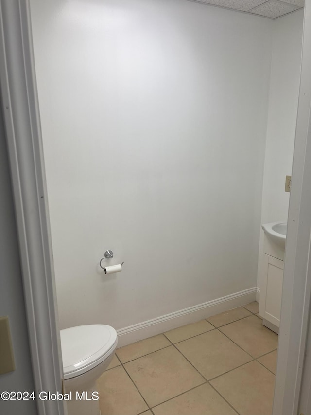 bathroom with tile patterned flooring, vanity, and toilet