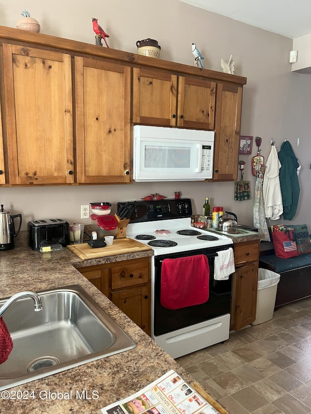 kitchen with sink and white appliances