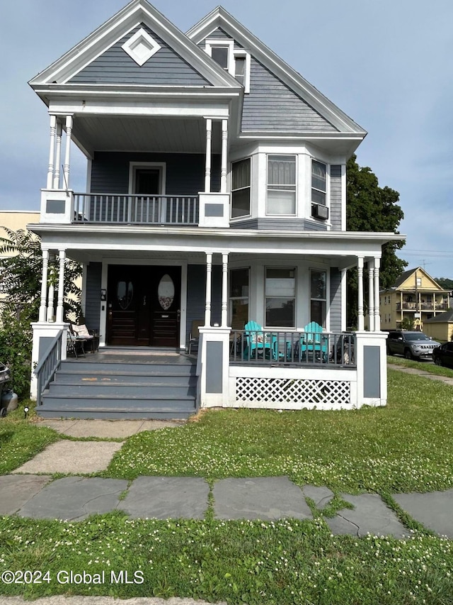 view of front of home featuring covered porch and a front yard