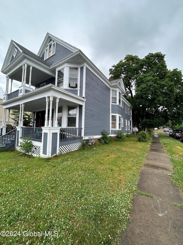 view of home's exterior featuring a lawn and a porch