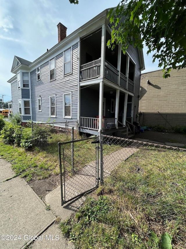 exterior space featuring a balcony and covered porch