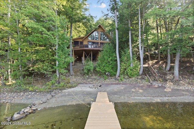 back of house featuring a deck with water view