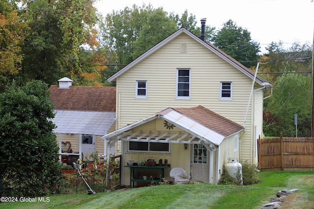 rear view of property with a yard