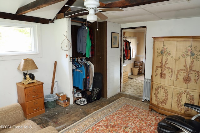 bedroom with ceiling fan and radiator heating unit