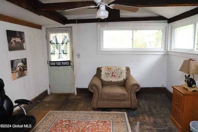 living area with ceiling fan, beamed ceiling, dark hardwood / wood-style flooring, and a healthy amount of sunlight