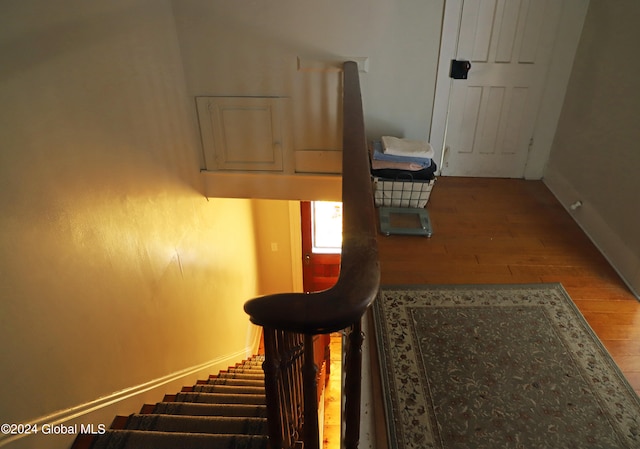 hall with hardwood / wood-style flooring