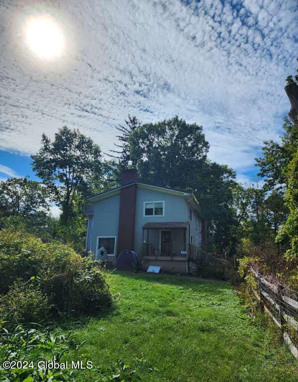 exterior space with a sunroom and a yard